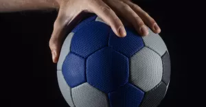 close up hand holding handball ball
