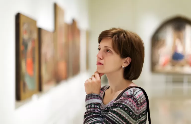 visitor looking pictures art gallery