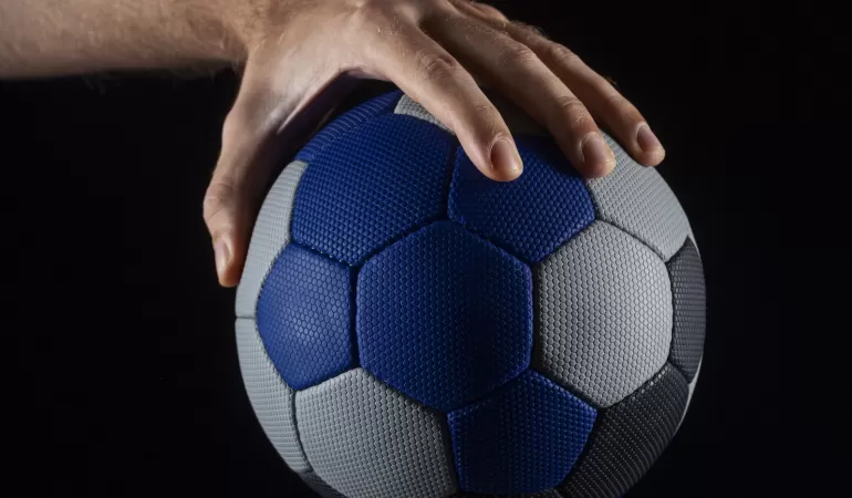 close up hand holding handball ball