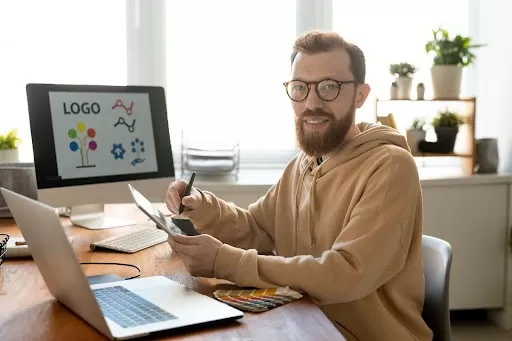 grafik przygotowujący projekt naklejki która będzie reklamowała firmę